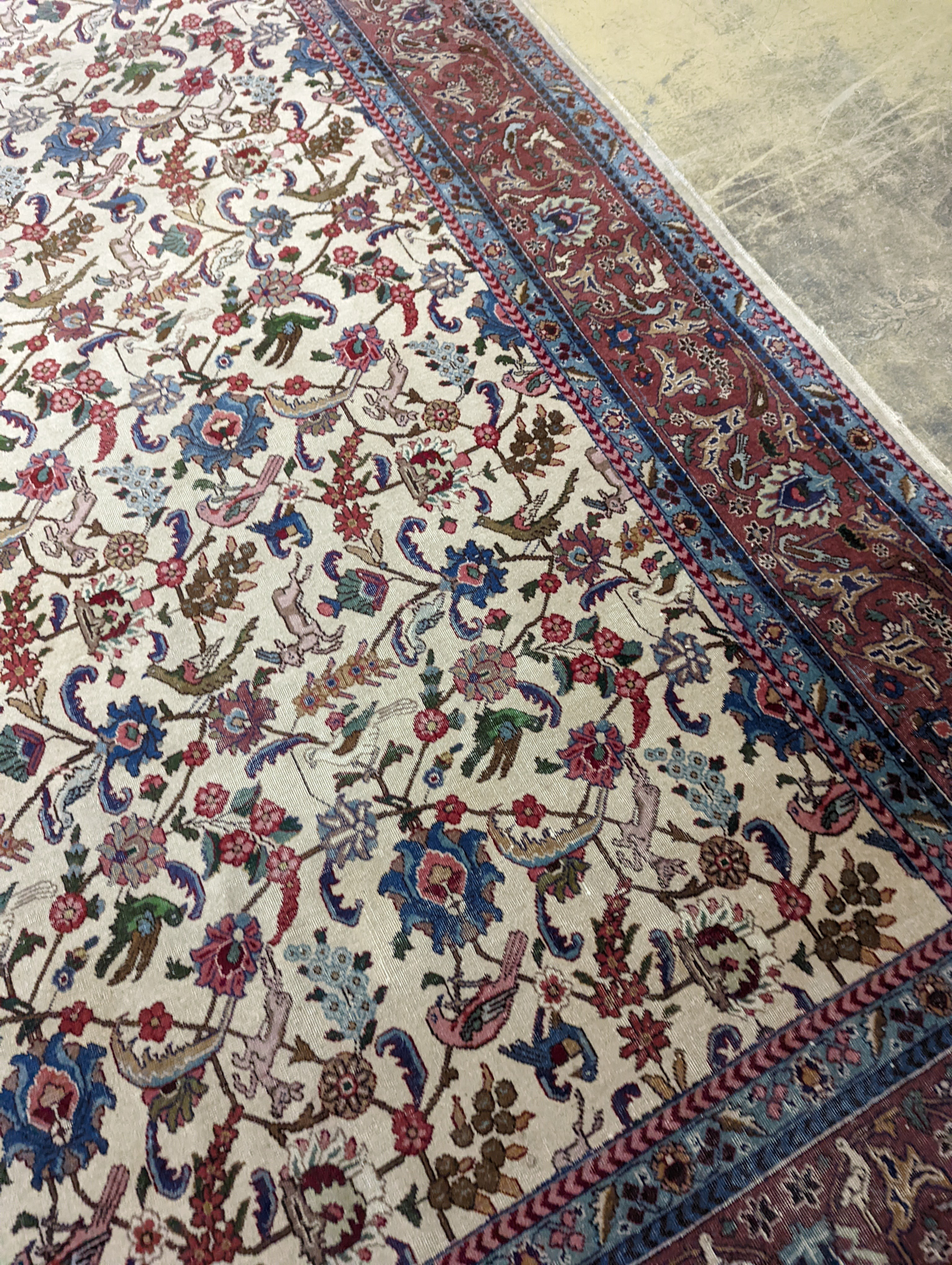 An Ispahan ivory ground carpet woven with flowers and animals, 386 x 276cm